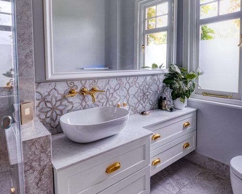 Brass, marble and travertine bathroom