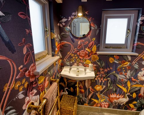Cloakroom with funky wallpaper with birds and flowers