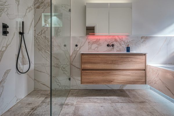 Modern family bathroom in Hampton with marble tiles and wooden vanity unit